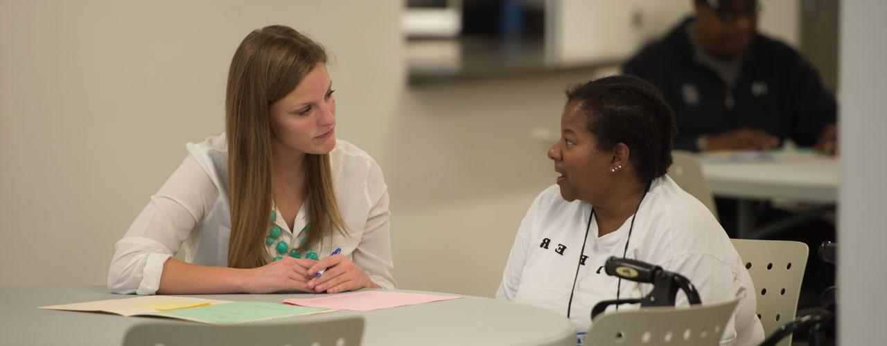 Pharmacy student discusses with patient